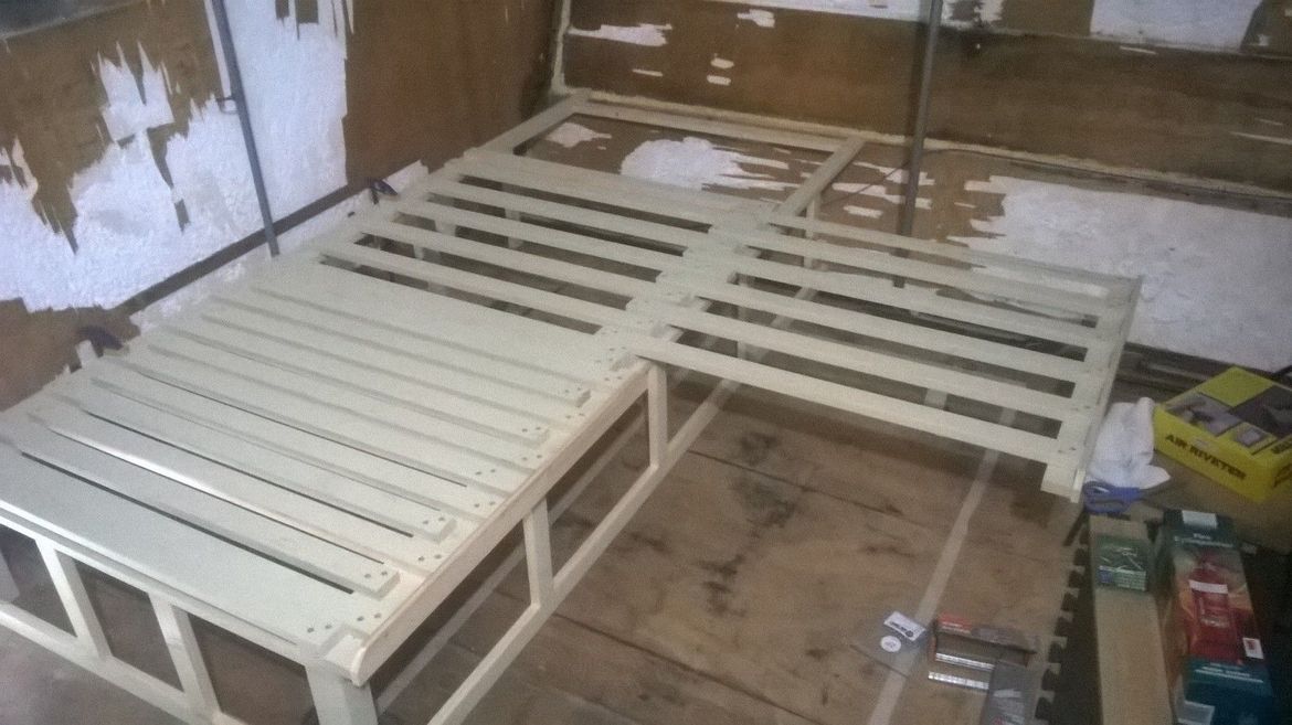 There are 2 sections to reduce the weight as both are hinged for access to storage underneath.