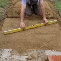 5.2 Use a screed bar to smooth and level the surface.jpg
