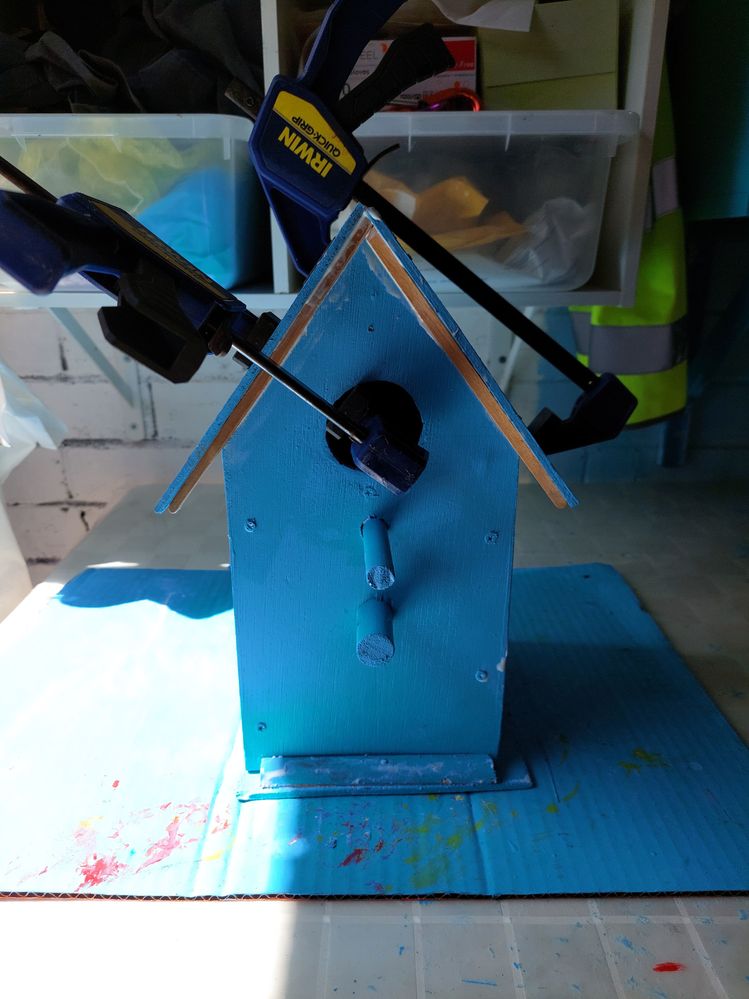 When we got the roof into position, we used clamps to hold it in place while the glue dries and filled the gaps with scrap wood.