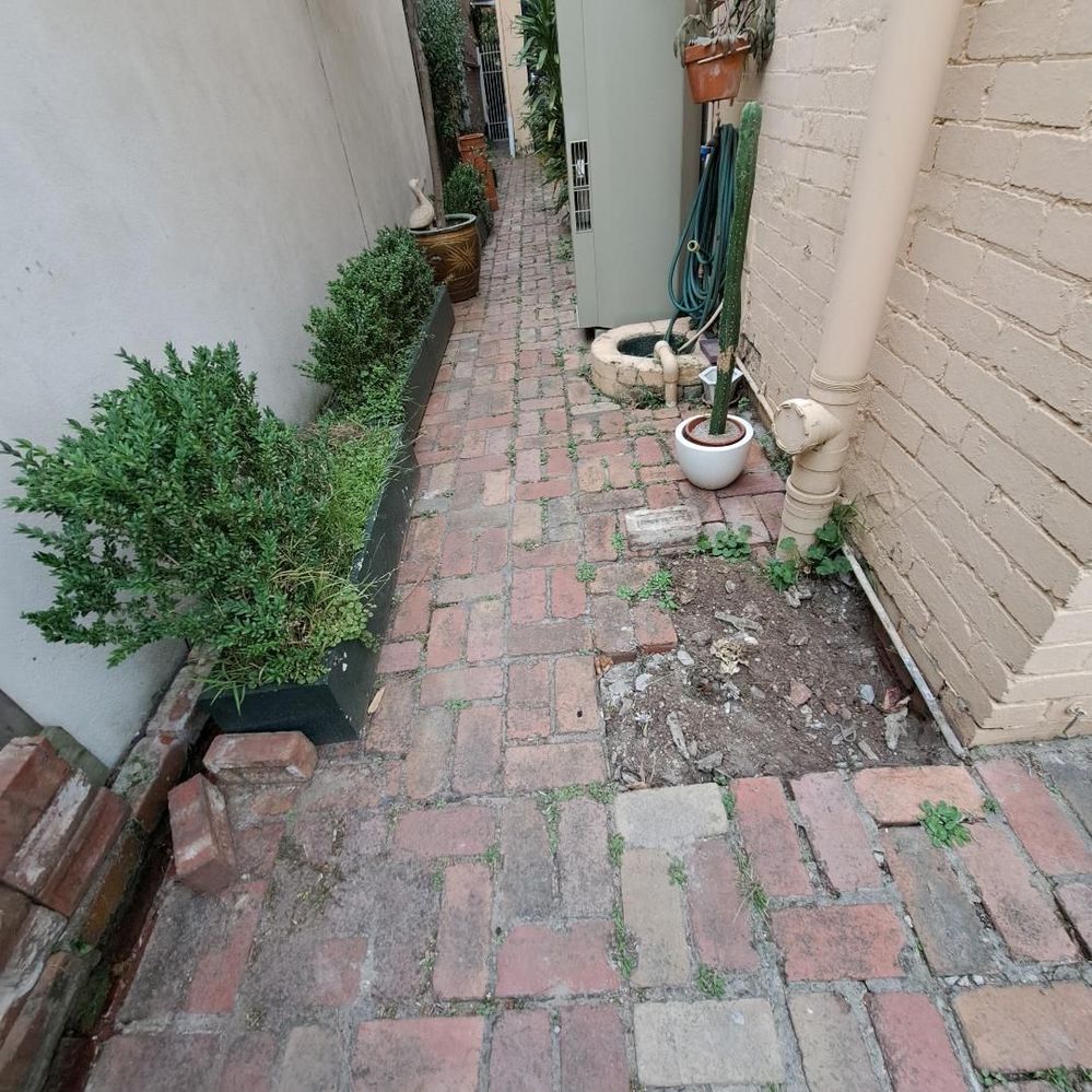 Back door bricks - side of house near the back door - sloping slightly to drain at side of property.jpeg