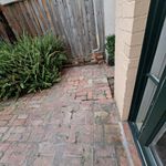 Back door bricks - slight slope to drain at side of property which goes out all along edge to alley.jpeg