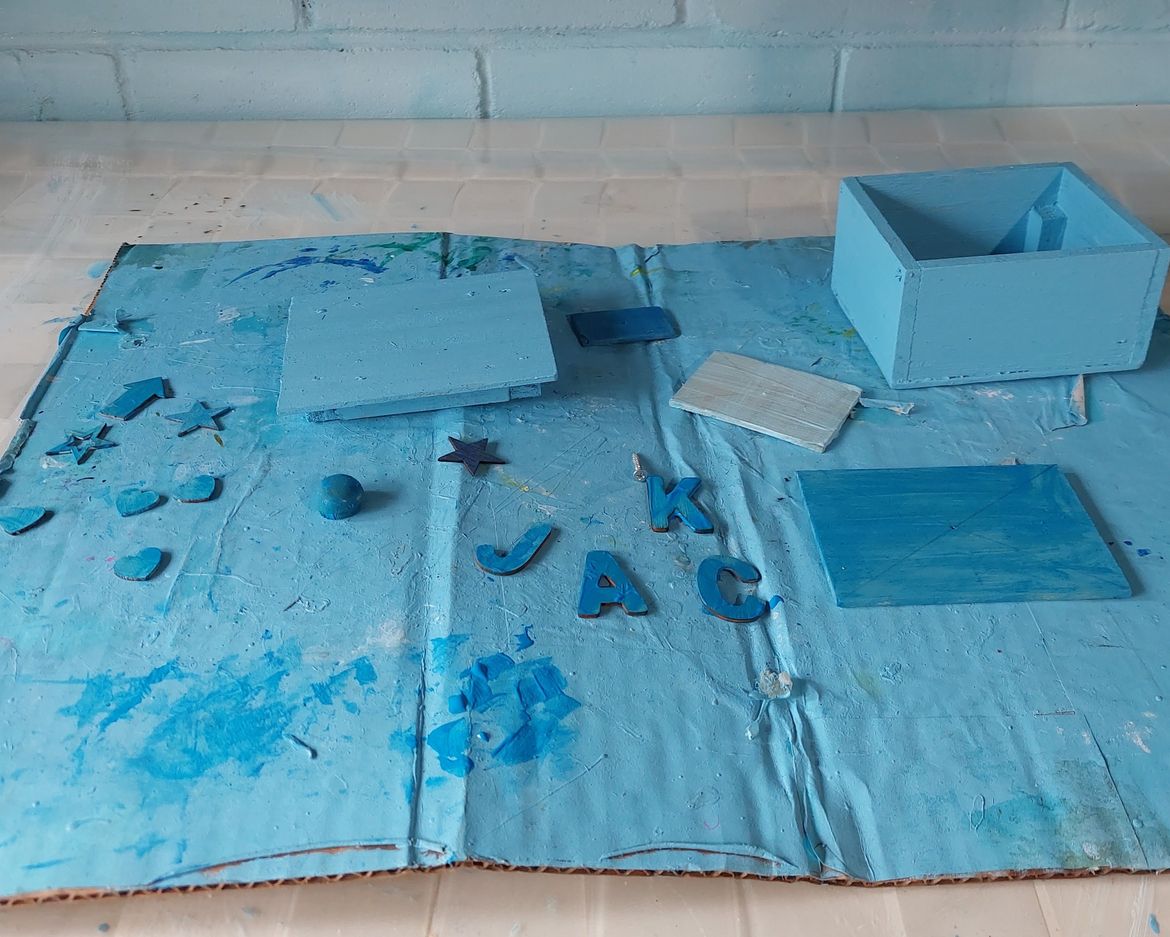 Jack used different shades of blue for the lid pieces and some wooden shapes.