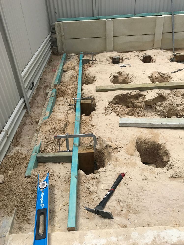 I used F Clamps to hold the posts in position while I poured the concrete