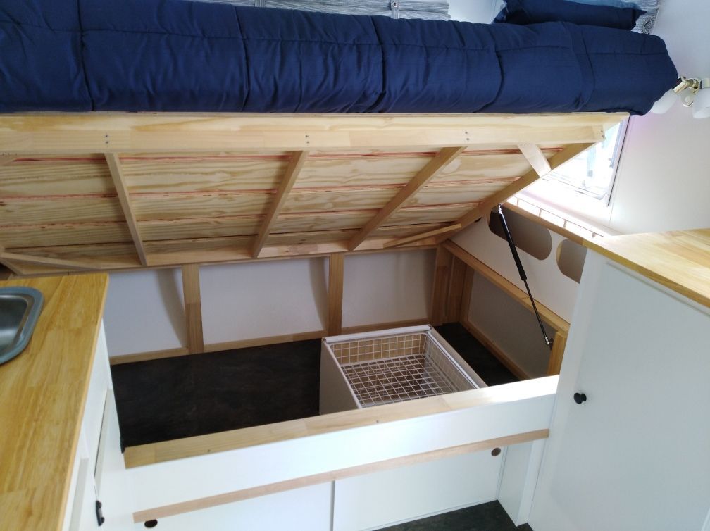 Storage accessible with either lifting bed up or using sliding doors underneath, basket drawers slide out on runners for quick access.