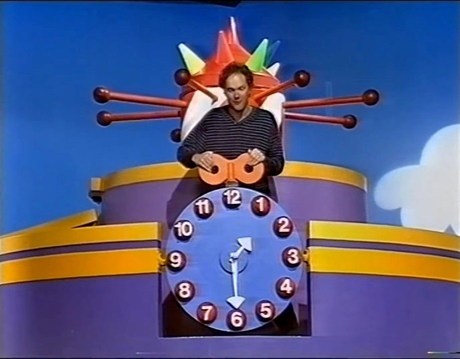 after they tell the time they turn the winding thing to make the trolley come down