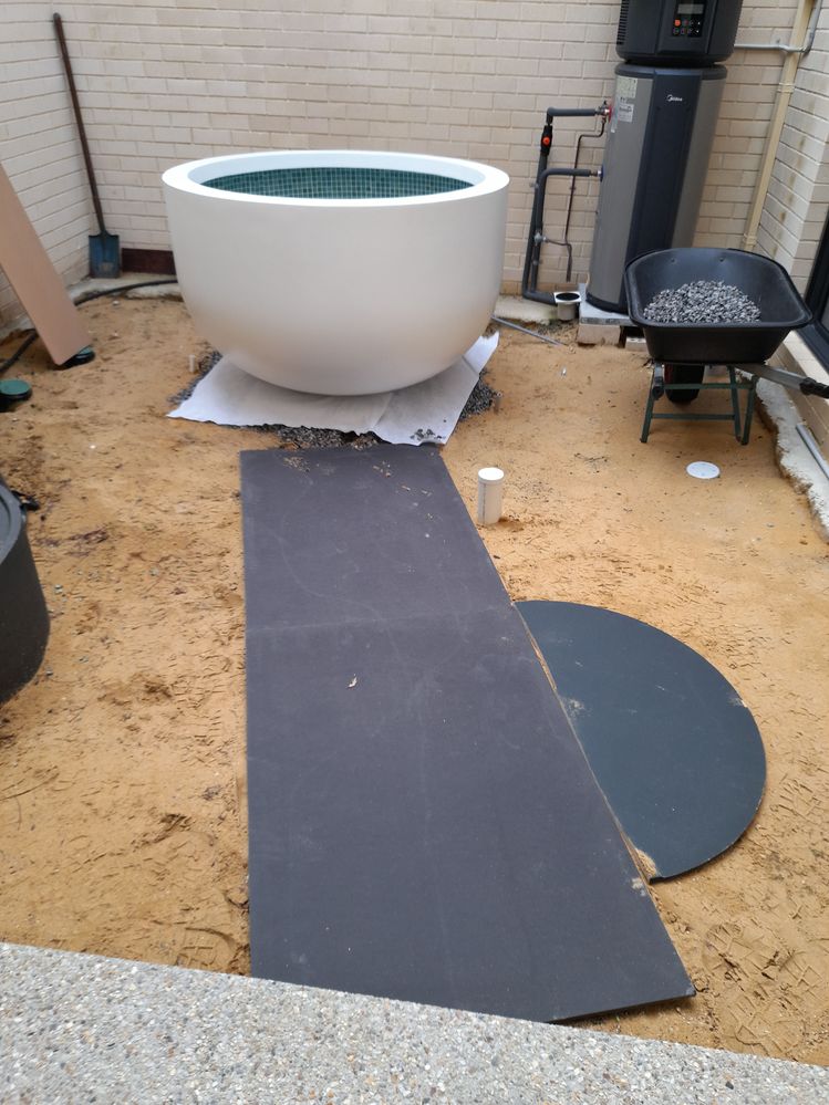 Getting planter in place on a bed of aggregate.