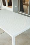White grid tiled outdoor table