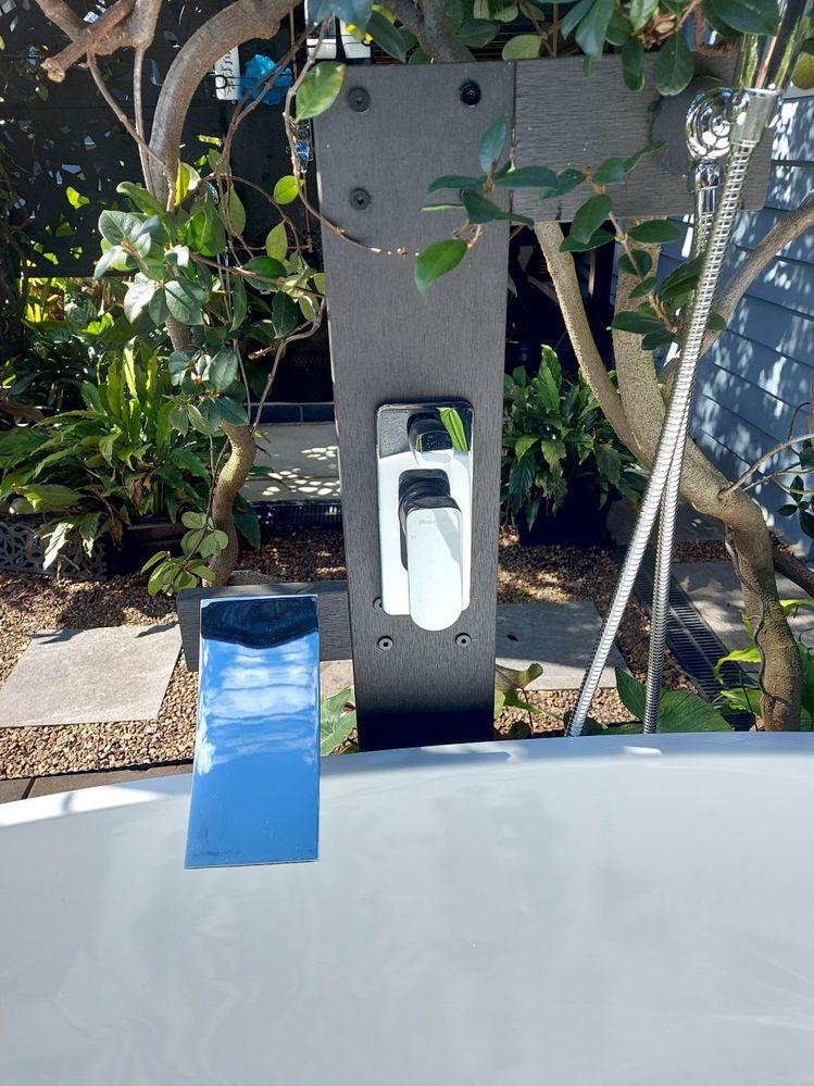 composite decking board in place and shower diverter and tapware attached