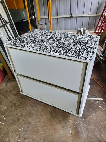 Adding film to top to cover fixings.