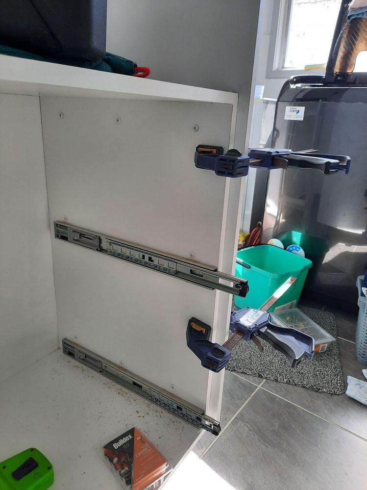 Sides screwed to base cabinet from inside with white cabinet screws