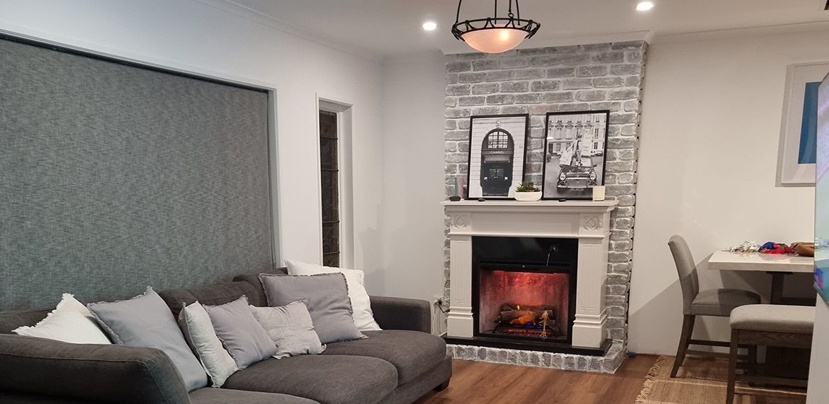 Living room renovation with whitewashed fireplace.jpg