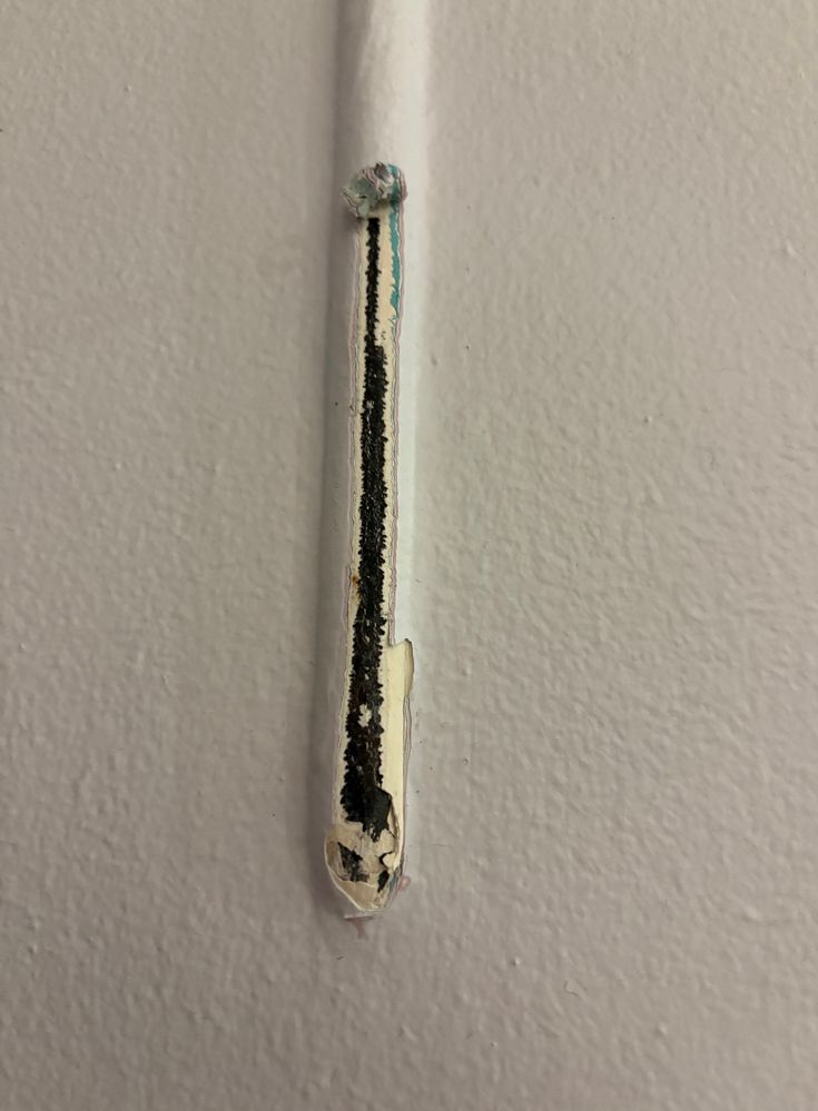 Tube to the immediate left of the door (leading into wall?)