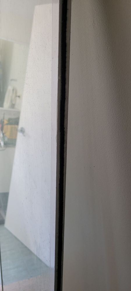 Photo of edge of shower screen shower "adhesive"