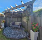 Corner pergola with screening and swing.jpg