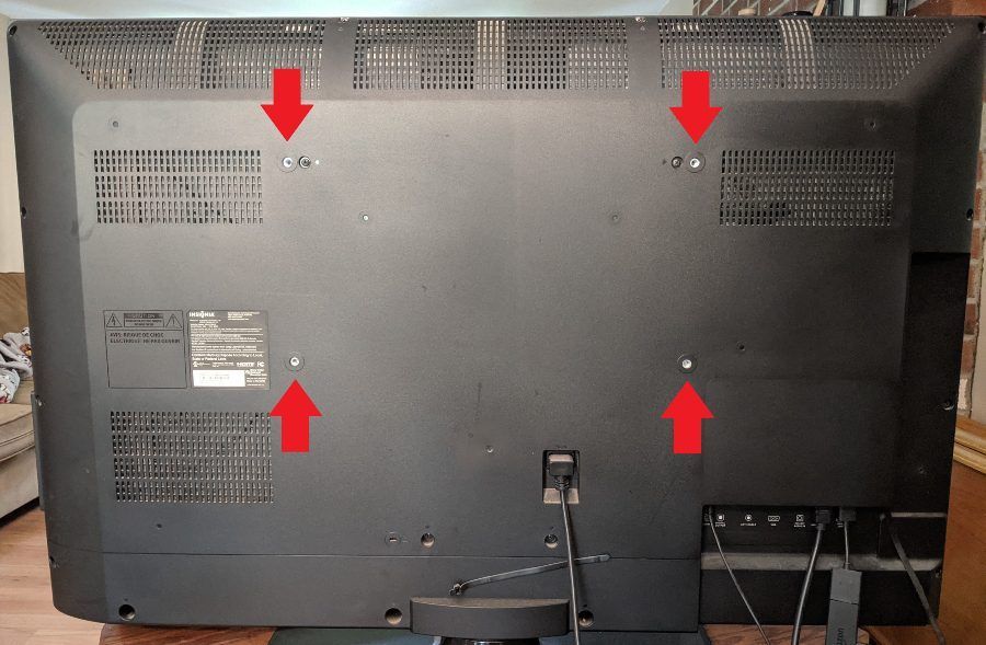 Typical mounting bracket holes to a TV with a slight curve in the back
