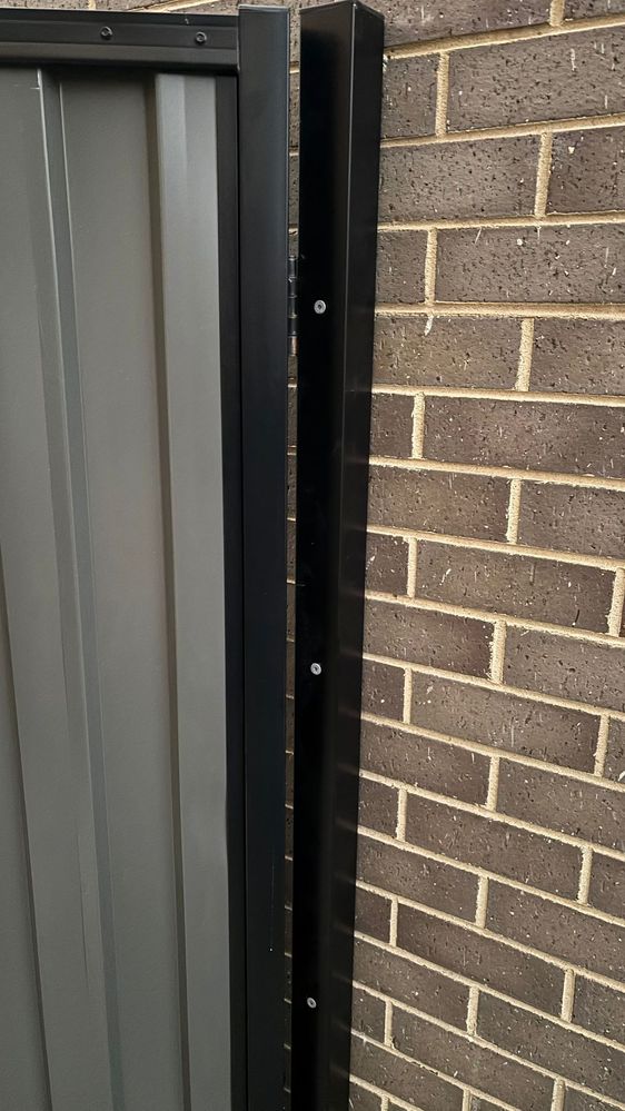 Pole secured to wall 2