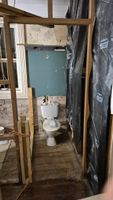 Old toilet mocked up in position with position of dividing wall laid out