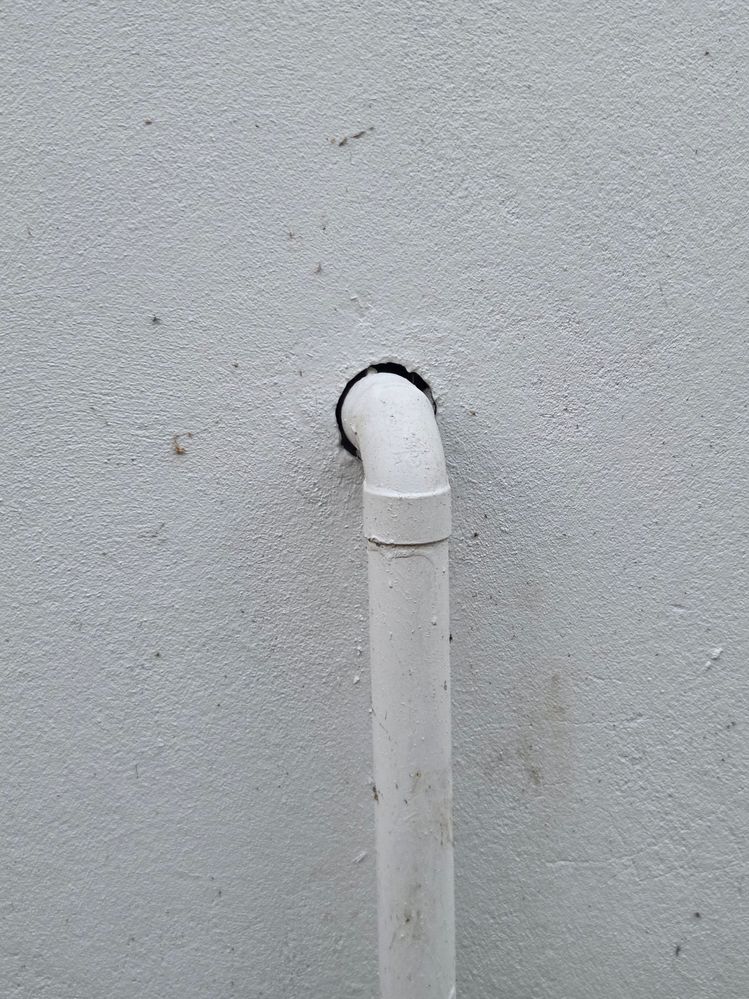 PVC pipe coming out from double bricked wall (about 30mm diameter)