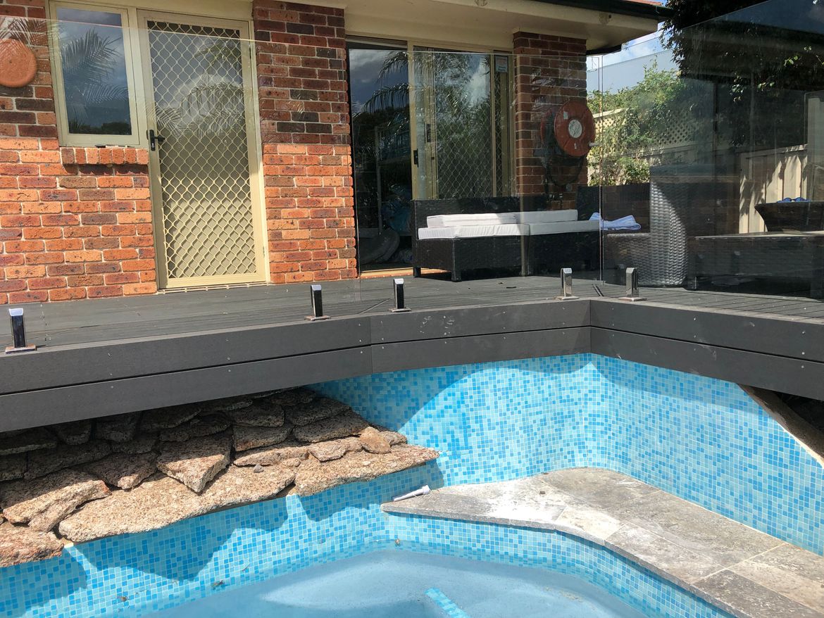 Tiles around pool and deck above