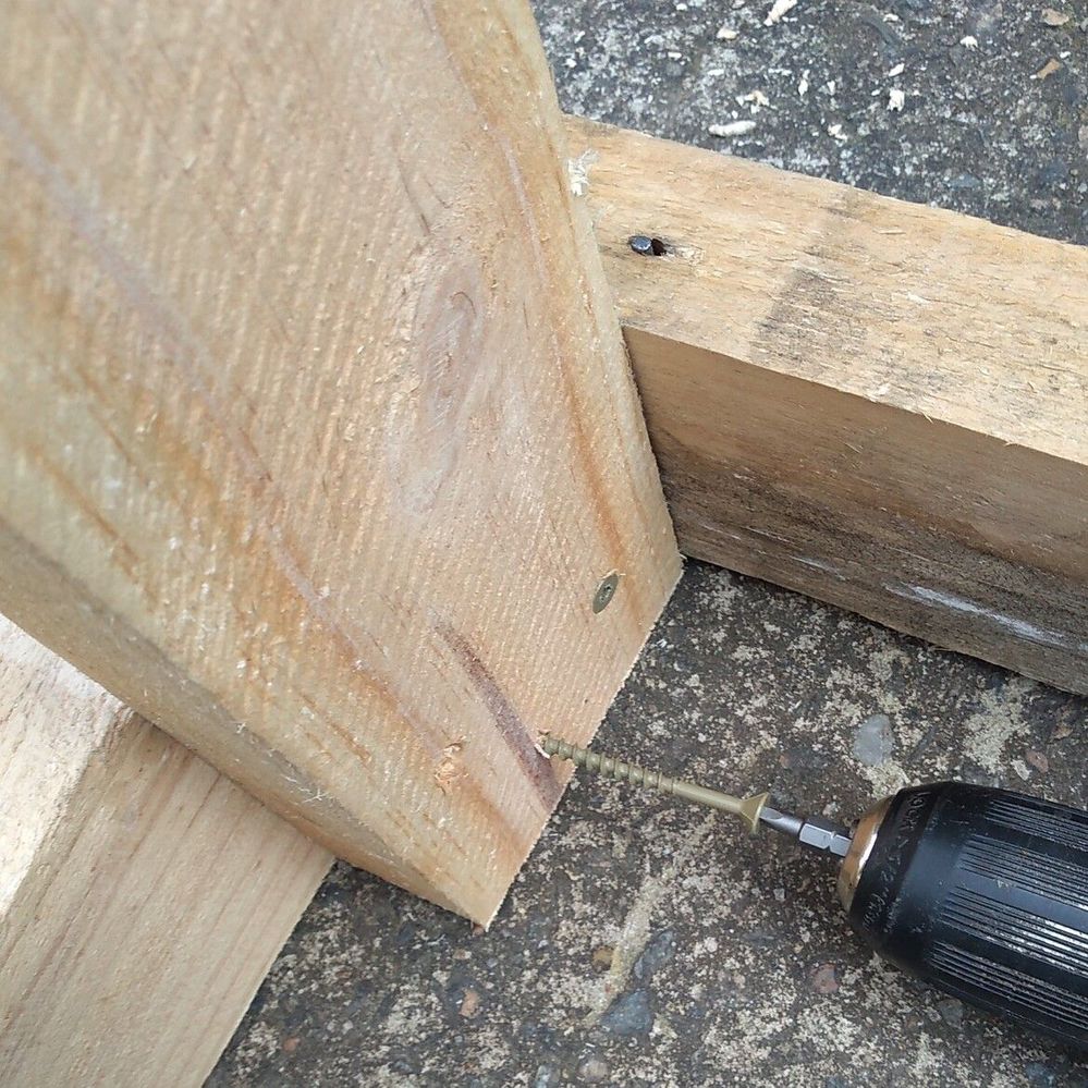 3.2 Fixing Upright posts into place between two frames.jpg