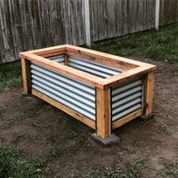 Raised garden bed using Cypress and corrugated iron
