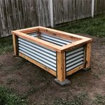 Raised garden bed using Cypress and corrugated iron