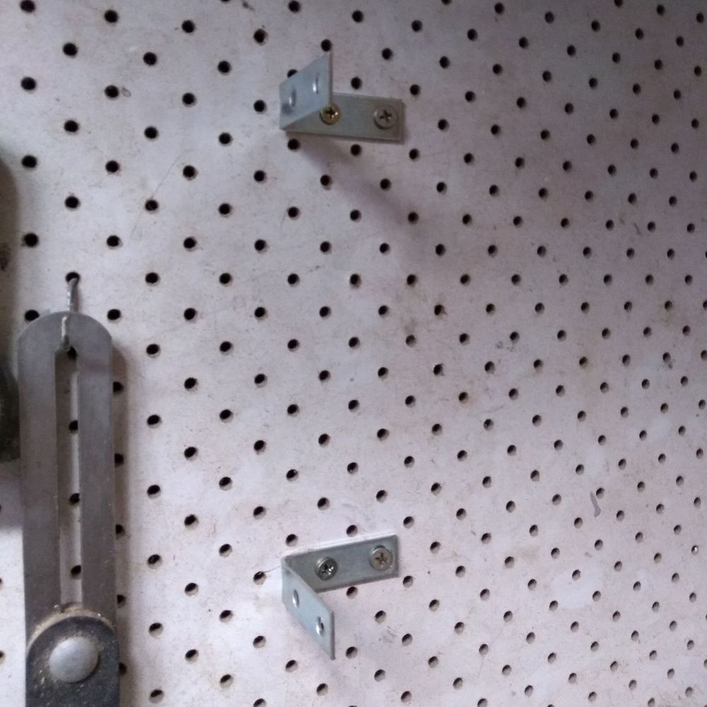 10.3 Attaching brackets to wall.jpeg