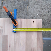 2.4 Kreg guide clamped in position on middle of upright board.png