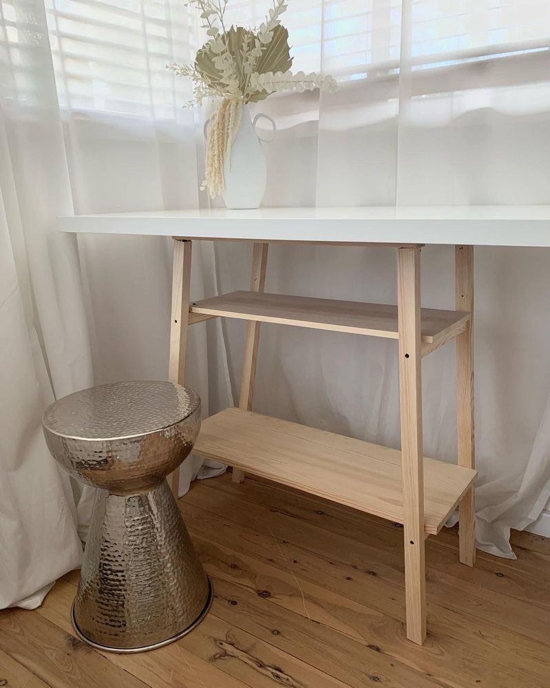 A tabletop on a timber planter stand.