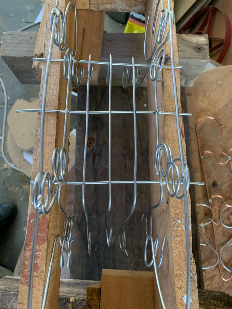 Using the end of a pallet, and hanging the items that need to sit vertically.