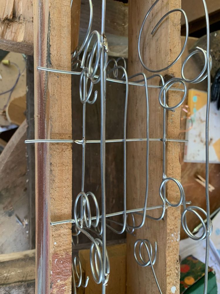 Another photo, if the sides don't hang perpendicular, to the cross members, pegs can be used as weights.