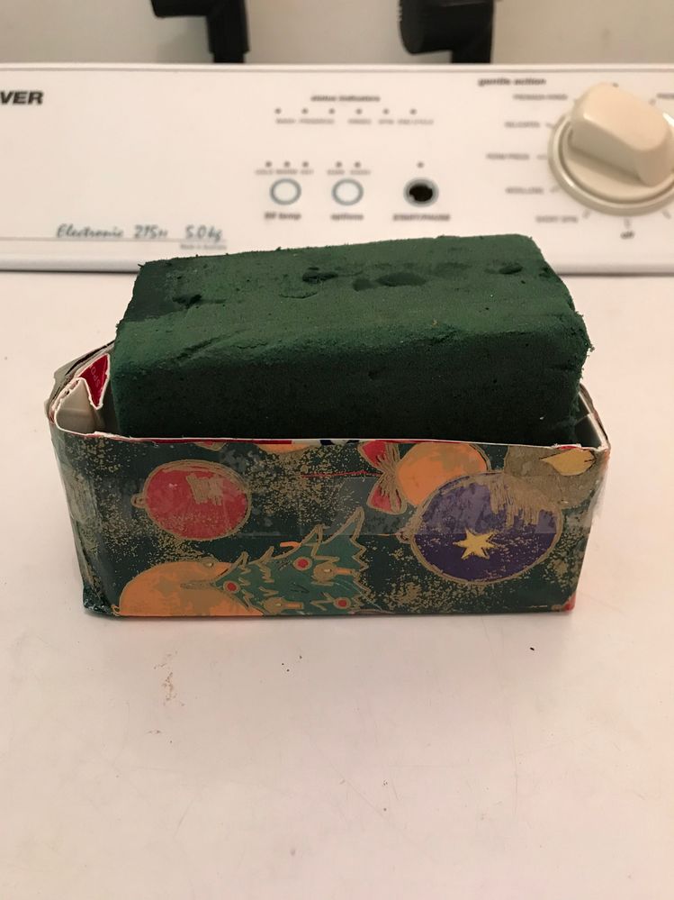 Now for the arrangement. If using flowers, there is floral art foam. Notice that the top of the foam is above the edge.