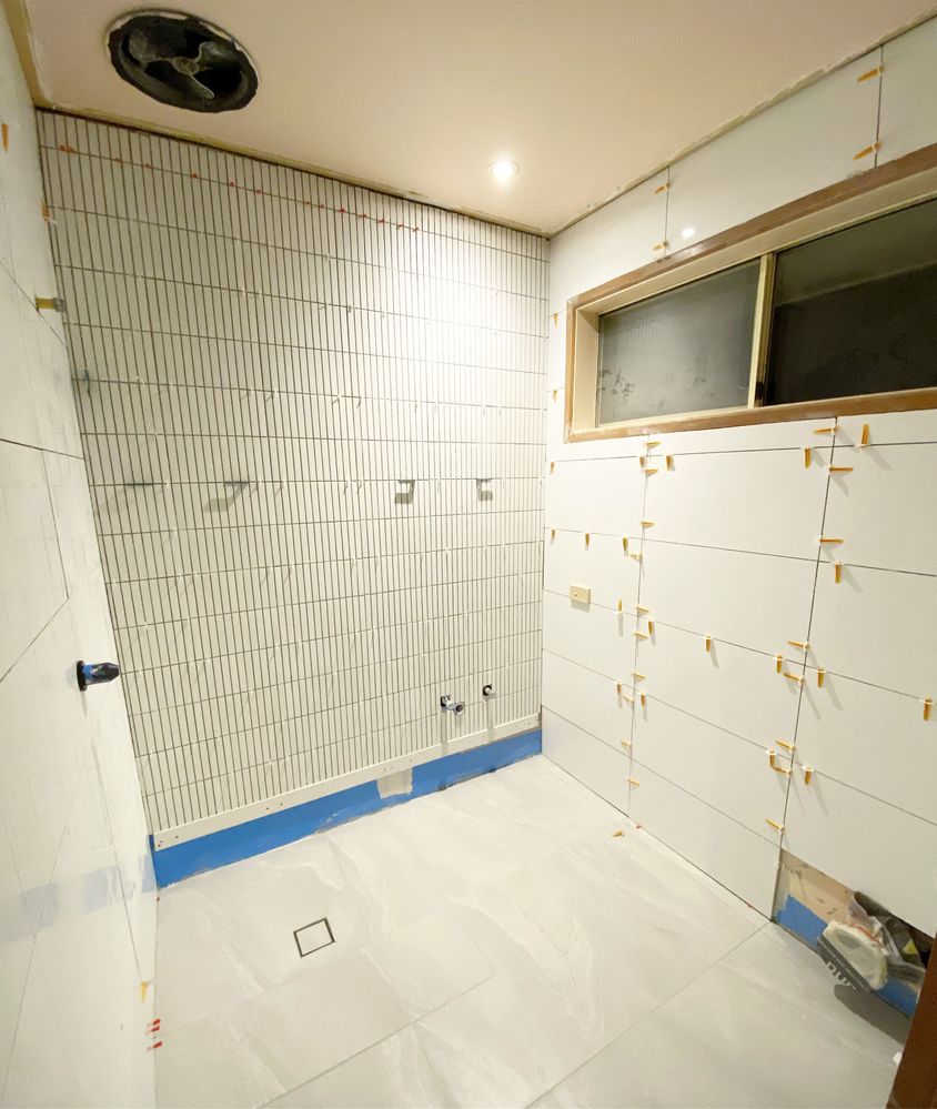 Wall and floor tiling with large format and mosaic.