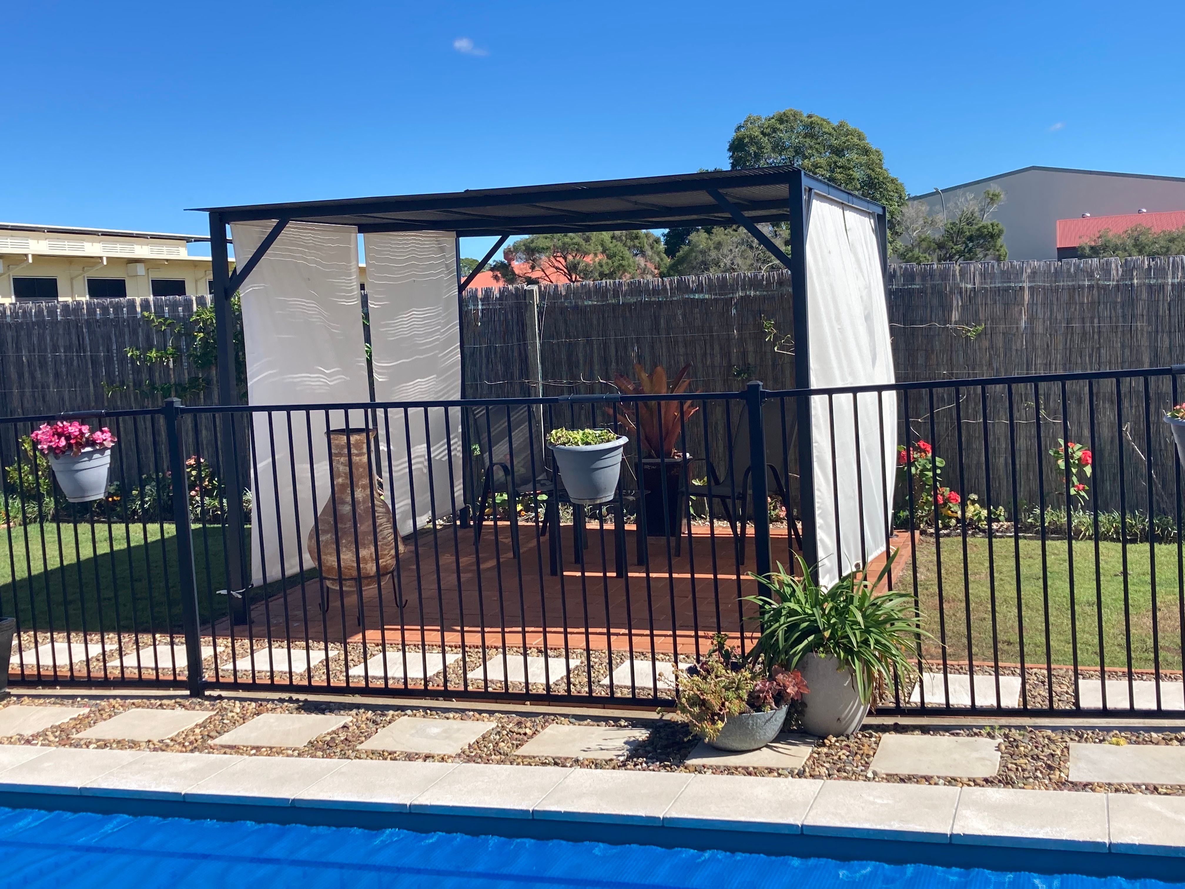 Outdoor cabana and poolside paving Bunnings community