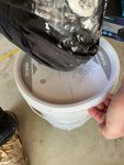 The easy way to get stubborn lids off plastic paint buckets! A knee firmly in the centre and peel one edge of the lid back.