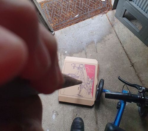 Killing a pizza box on a rainy day.