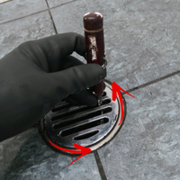 1.2 Using screwdriver to assist with opening waste grate.png