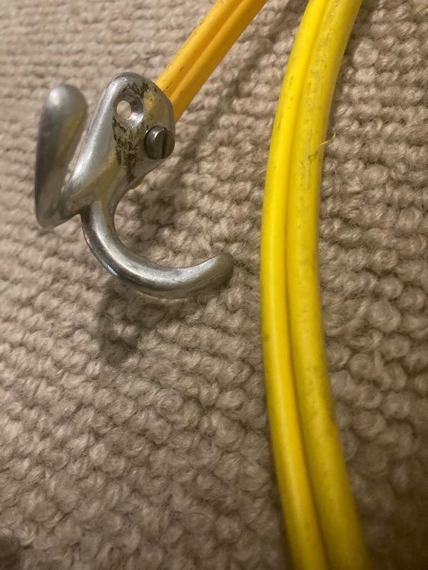Fitting an old wardrobe hook to the fishing tape helped raise the cable.