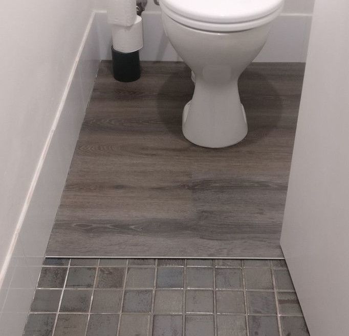 vinyl_flooring_over_toilet_tiles.jpg