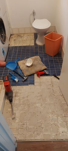 Used a hammer drill to lift the floor tiles