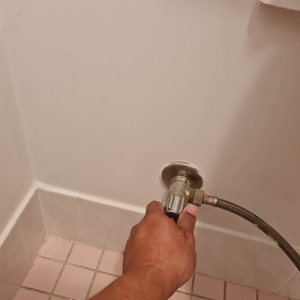 1.4 Turn off cistern tap clockwise.png