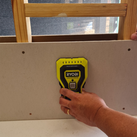 Step 3.1 Place stud finder on wall to calibrate.png