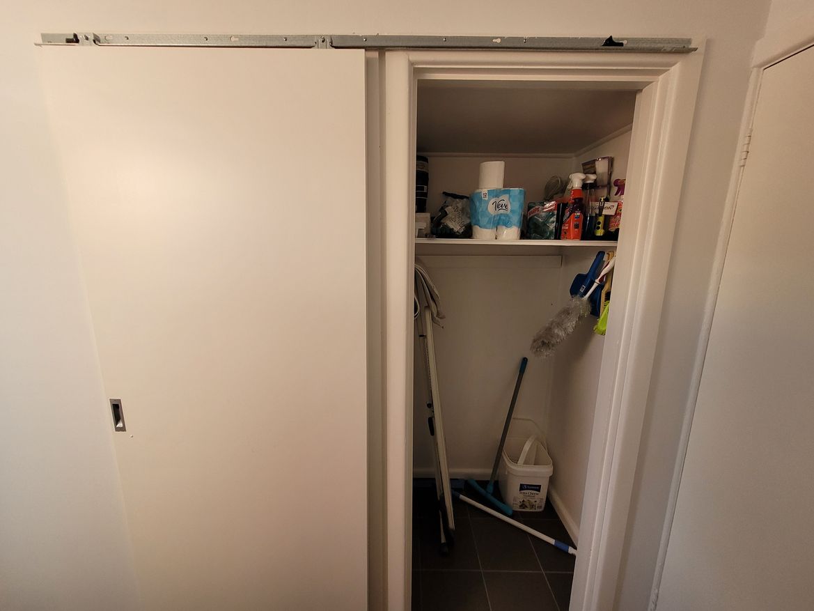 Door closed off to toilet, opens laundry cupboard
