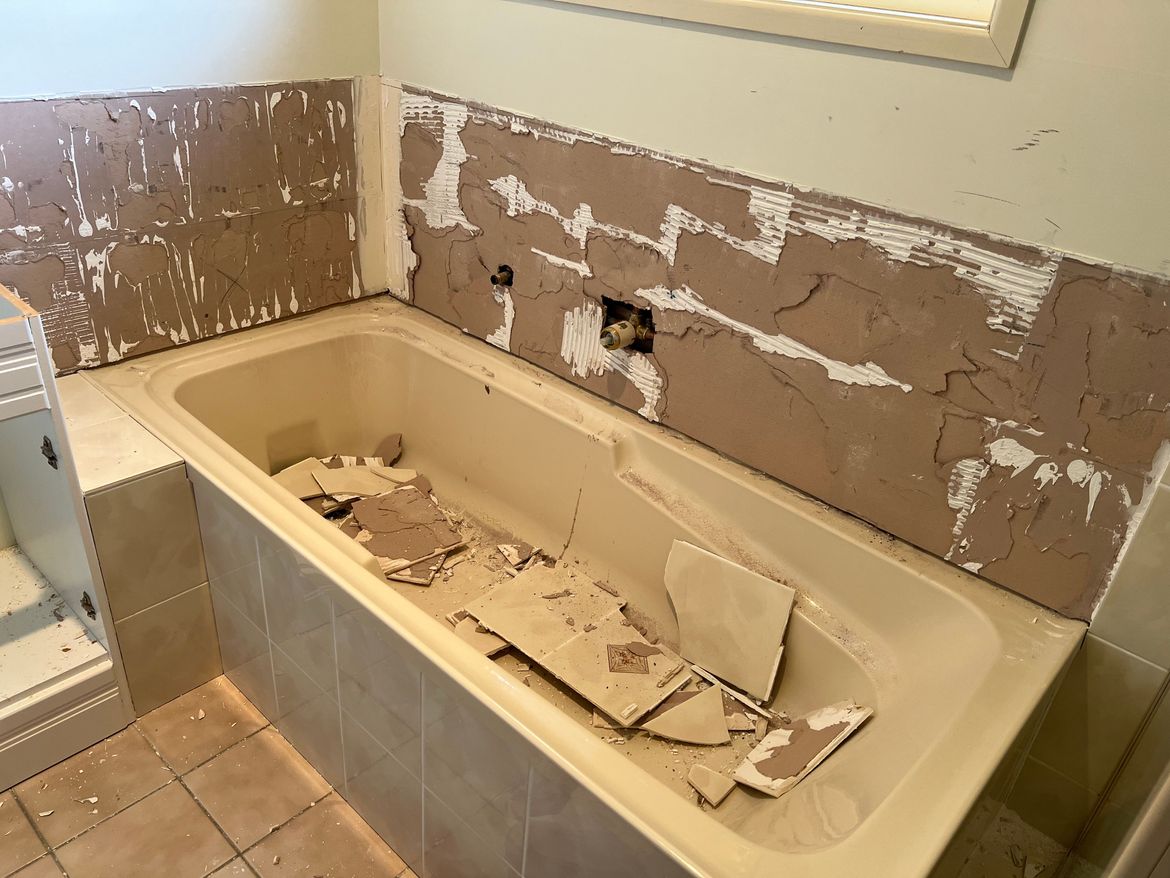 Removing tiles behind the bathtub