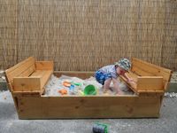 Sandpit with fold-out seats