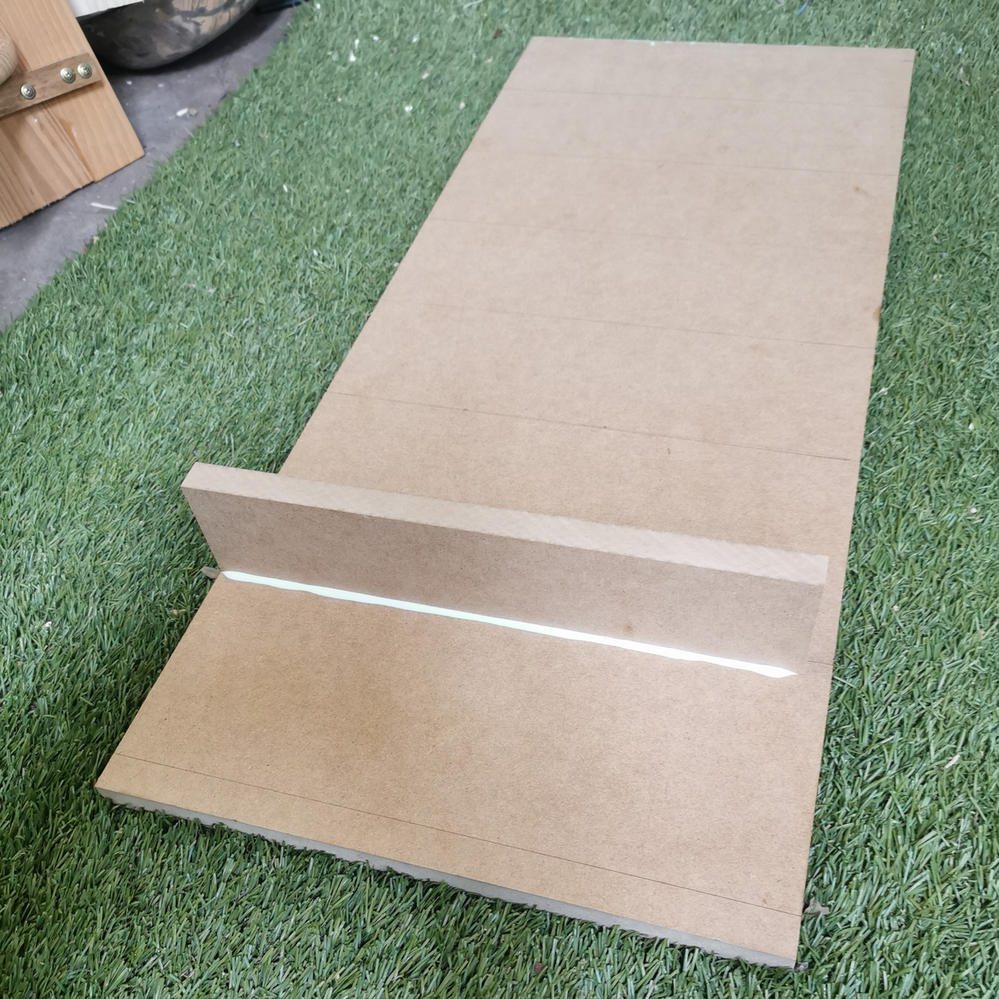 4.3 Gluing first rail piece in position.png