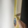 5.2 Applying painters tape around architrave.png
