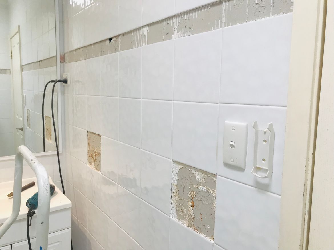 Remove old trim tiles and ceramic towle rail and soap holders etc..