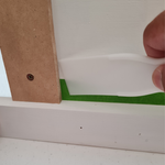 Step 2.9 Push first tape corner in.png