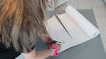 Measuring and cutting the wallpaper for the panels.
